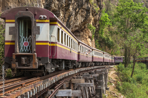  passenger thai train moving on death of railway world war II between tham krasae railway station river kwai kanchanaburi Thailand 