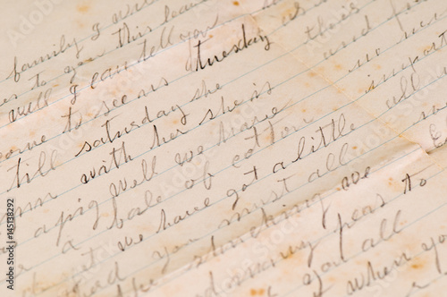 Vintage distressed aged handwritten letters with a shallow depth of field background