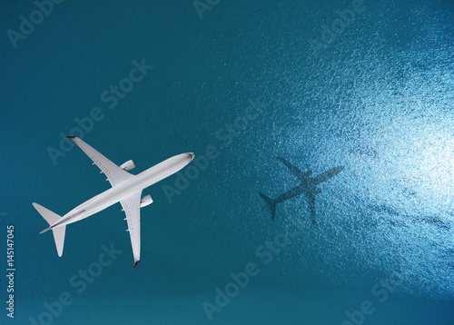 Airplane flies over a sea, view from above