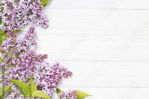 lilac flowers on the white wooden background.