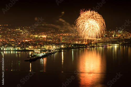 Fireworks for anniversary over Port Varna at night with reflections on the water