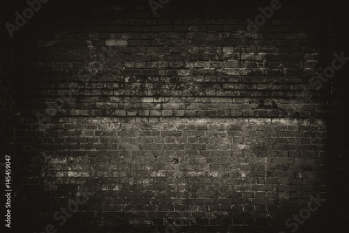 Dark room with brick wall background