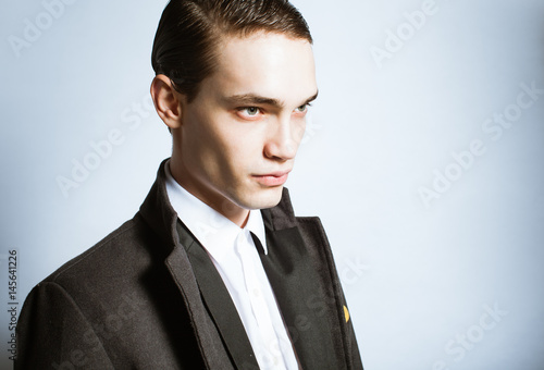 Portrait of male fashion model posing in suit.