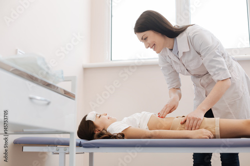 Nice pleasant girl lying on the medical bed