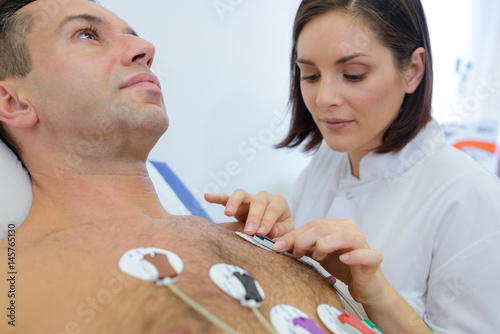 nurse attaching a body monitor