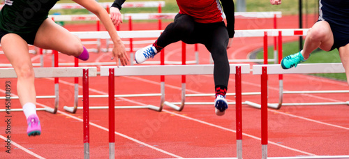 High School girls racing in the hurdles