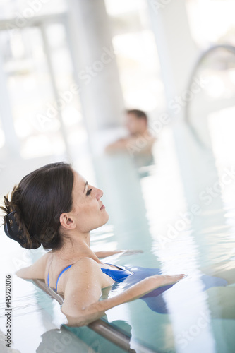 Beautiful brown woman relaxing in thalassotherapy thermal water