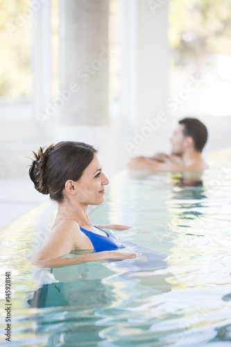 Beautiful brown woman relaxing in thalassotherapy thermal water