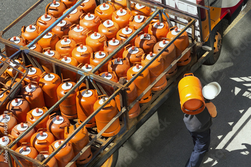 gas bottles with butane in truck with worker for delivery , lpg glp