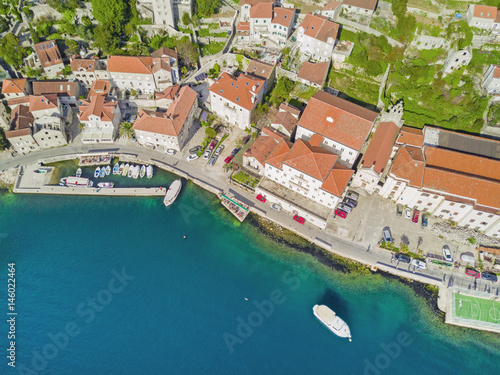 Top view of a beautiful city with red roofs near the sea