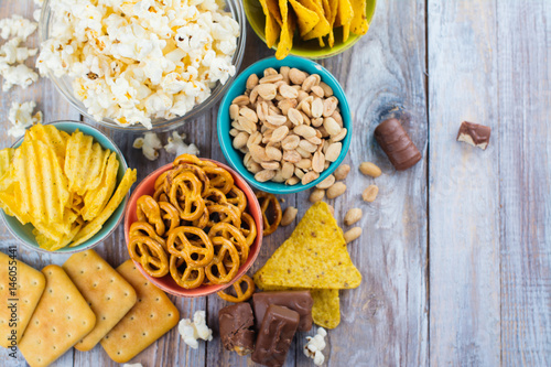 Unhealthy snacks on wooden background