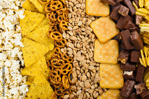 Unhealthy snacks on wooden background