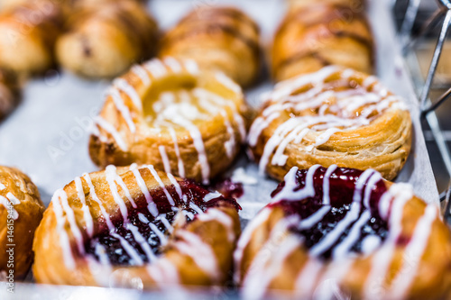 Small cheese and jam danishes in powdered sugar macro closeup