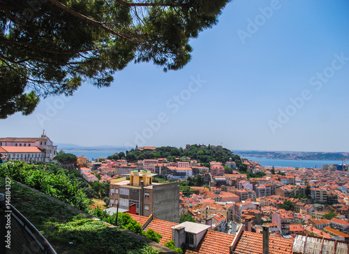 Lisbon skyline with fortress on the hill viewed from famous viewpoint