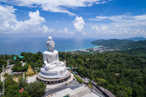 White buddha statue on top of the mountain with blue sky in Phuket