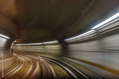 Inside tunel blur abstract scene traveling by train looking forward In Italian subway