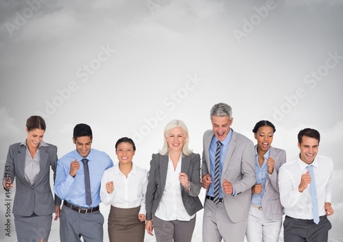 Business people happy having fun under grey sky