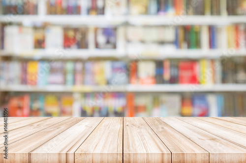 Empty wooden table top with Blur bookshelves in bookstore background.