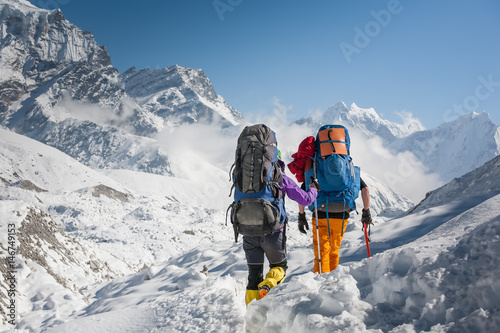 Trekkers crossing Gokyo glacier in Khumbu valley on a way to Everest Base camp