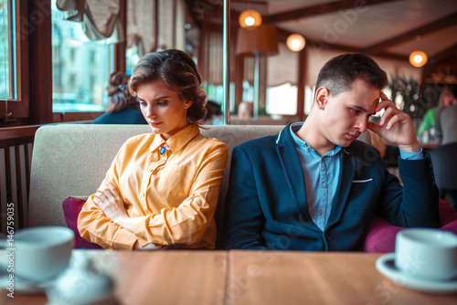 Couple in a bad mood sitting in restaurant