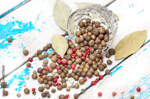 Spices are scattered on an old table.