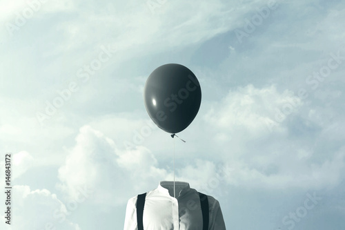 surreal man with big black balloon suspended over his head