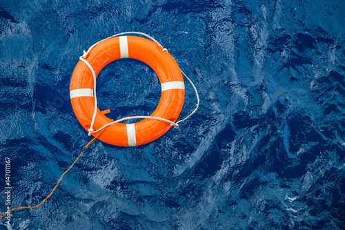 Safety equipment, Life buoy or rescue buoy floating on sea to rescue people from drowning man.