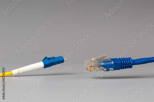 Close-up of optical patch cord lc and copper cable with plug rj45