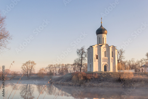 View to the Church of the Intercession of the Holy Virgin on the Nerl River in sunlight.
