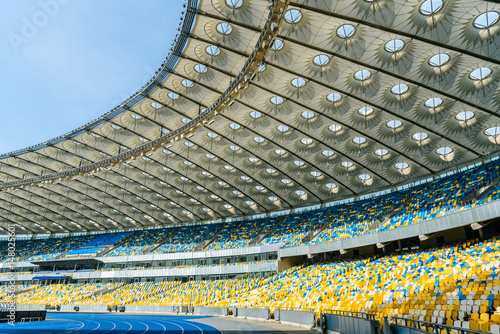 rows of yellow and blue stadium seats on olympic stadium