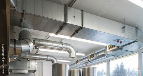 Ventilation pipe system in kitchen interior.