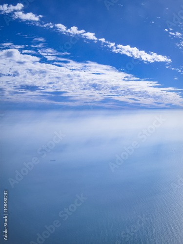 View of sea and clouds shot from a plane.