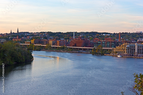 Georgetown Park along the river at sunset. Potomac River waterfront buildings in the evening.