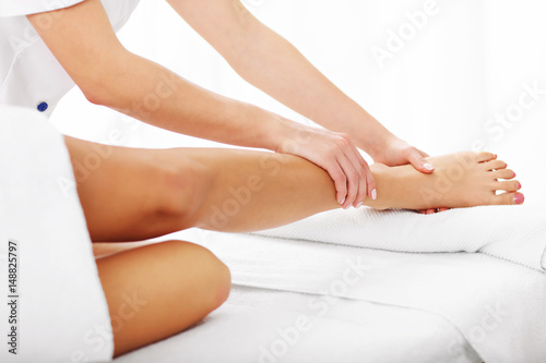 A picture of woman having leg therapy