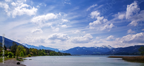 Panoramic view to lake tegernsee, bavarian tourist resort with the alps in the background, cloudy blue sky, bavaria, germany, europe