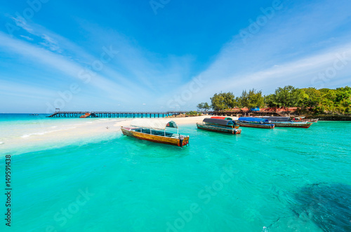 colorful exotic seascape with boats near Zanzibar shore in Africa