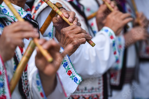 People singing at traditional wooden flutes