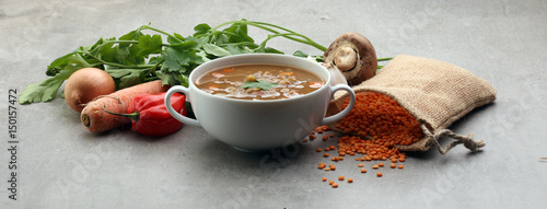 Lentil soup with pita bread in a bowl on a wooden background