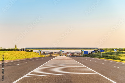 Multi-lane countryside asphalt road with marking. Intersection of the country roads on two levels. Disappearing into the distance perspective. Belgorod region, Russia.