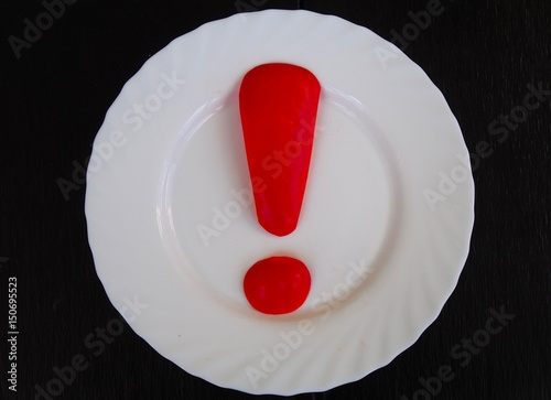 Red warning exclamation mark on white plate