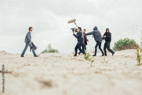 Behind the scene. Film crew filming movie scene outdoor