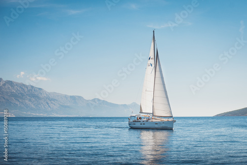 Sailing yacht in the sea against the backdrop of mountains