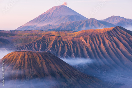 Vivid colors Bromo Semeru volcano mountain with sea clouds at sunrise in Java island in summer