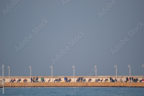 people sitting on a pier in sopot poland