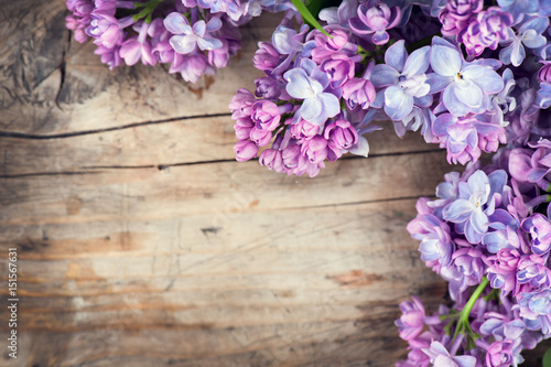 Lilac flowers bunch over wood background