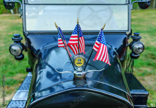 1924 Ford Model T Detail with Three American Flags / Essex, USA - August 2, 2011: 1924 Ford Model T with American flags flying on display at Tuesday evening car show on New England village green.