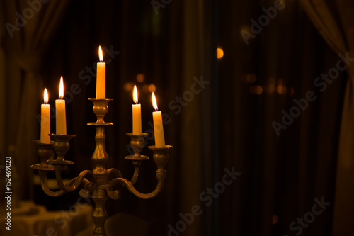 Metal retro candlestick with five burning candles