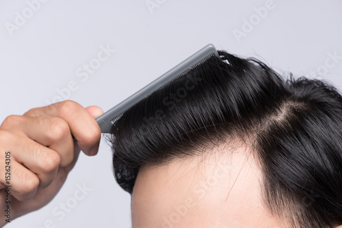 Close up photo of clean healthy man's hair. Young man comb his hair