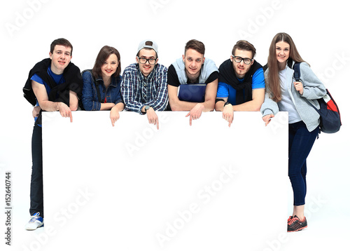 Full length portrait of confident college students displaying blank billboard against white background