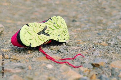 Lost running shoe. Tread of running shoe on rough sourface. Running concept.